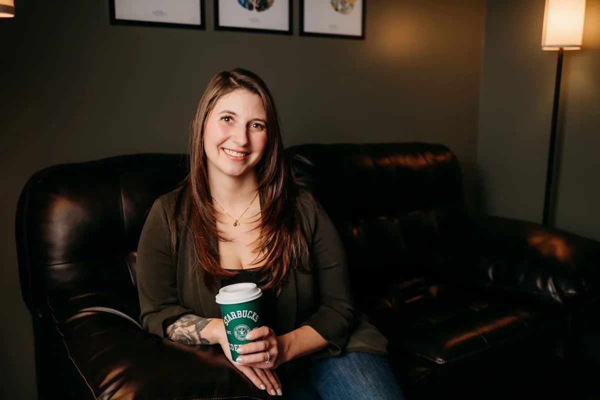 Jess Orr sitting on the leather couch in her therapy office